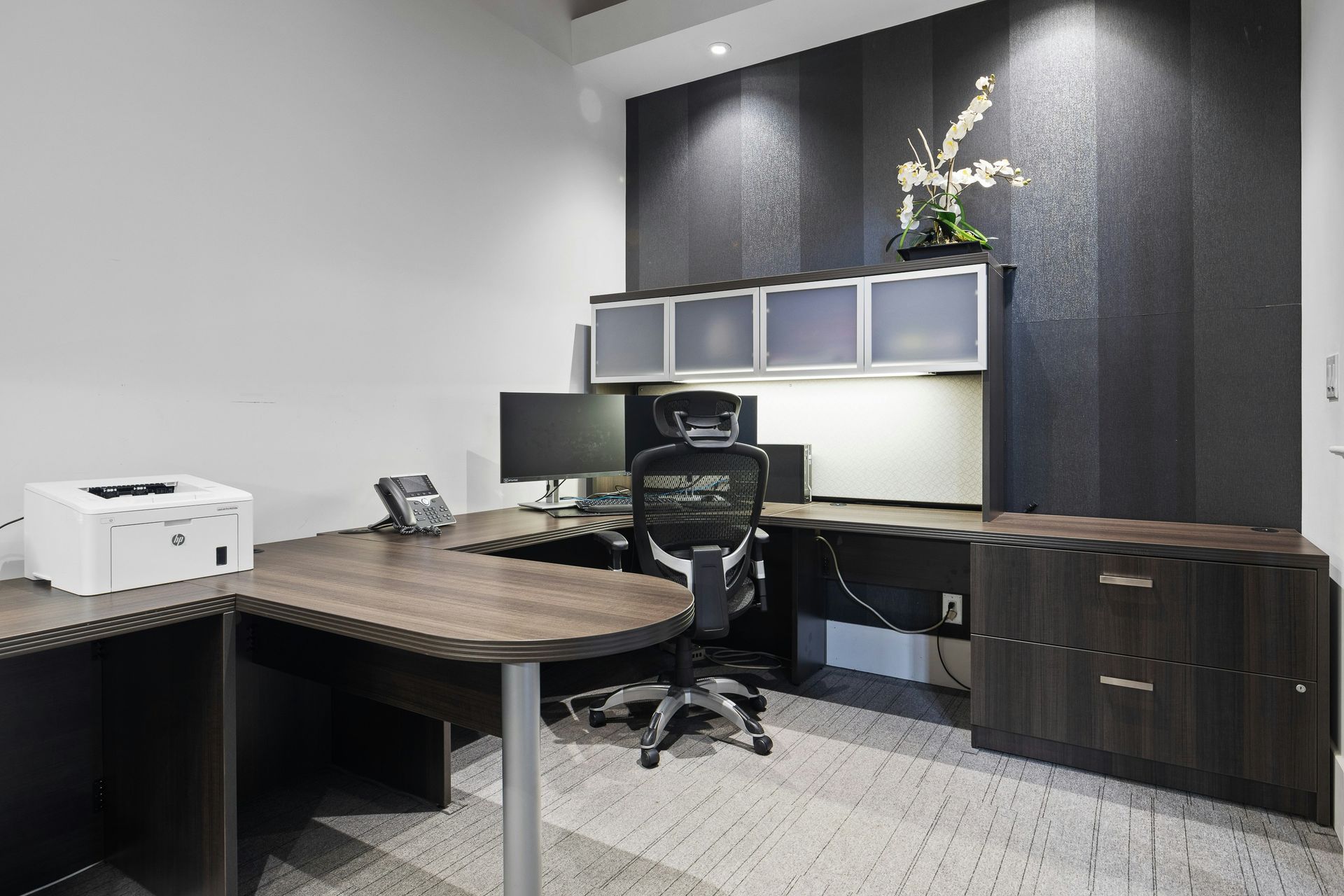 a desk with a chair and a printer on it